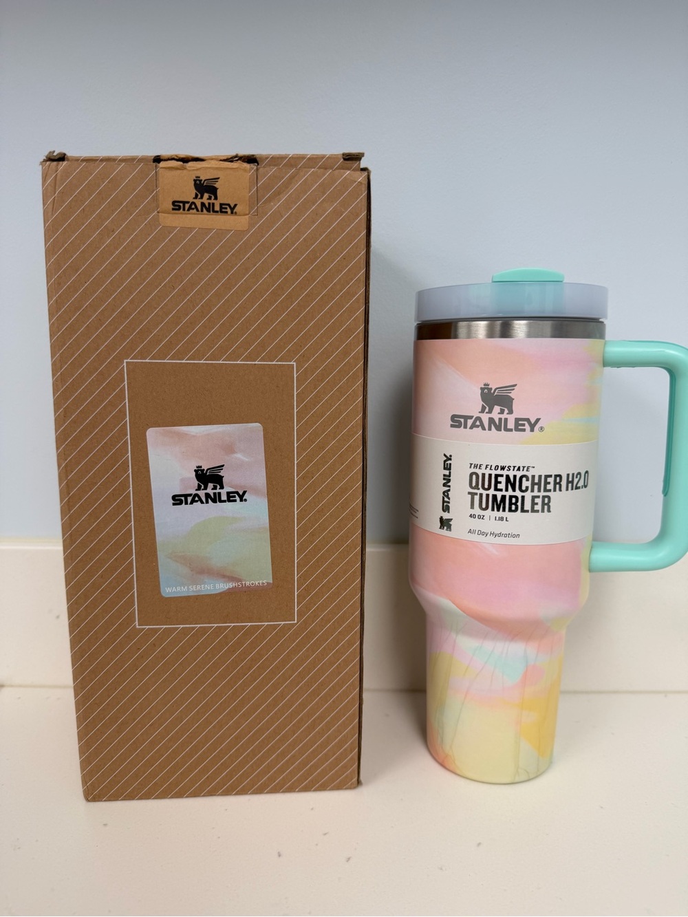 Stanley Pastel Swirl Quencher H2.0 Travel Mug 40 oz with straw in plastic wrap.